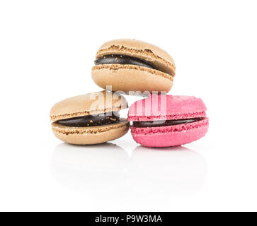 Tre francesi macarons (due al cioccolato, una rosa con lampone) isolato su sfondo bianco Foto Stock