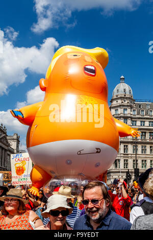 Anti Trump manifestanti portano un 'arrabbiato " Baby Blimp gonfiabile beffando il presidente attraverso le strade del centro di Londra, Londra, Inghilterra Foto Stock