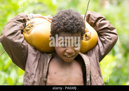 Ragazzo con noci di cocco - Yanaba Isola, Papua Nuova Guinea Foto Stock