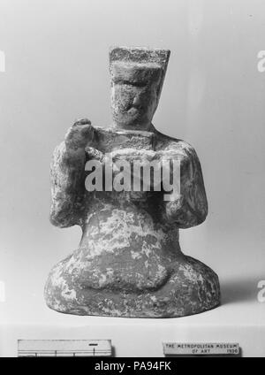 La figura dell animatore. Cultura: la Cina. Dimensioni: H. 3 1/2 in. (8.9 cm). Gli strumenti musicali rappresentati tra questo gruppo di figure in ceramica (36.12.1, .2, .10-.13, .16) sono tipici di quelli utilizzati nella musica popolare del periodo Han (206 A.C.-A.D. 220). Gli strumenti erano tutte lunghe storie, avendo esistito per secoli, nel caso della cetra, o millenni, nel caso del flauto (oggi mancante dalla figura del flautista). Museo: Metropolitan Museum of Art di New York, Stati Uniti d'America. Foto Stock