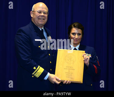 Adm posteriore. Richard Gromlich, Comandante della Guardia Costiera XIII quartiere, presenta Petty Officer 1. Classe Jamiee Baker, un yeoman assegnato alla Guardia Costiera Seattle di base con i soldati del premio di anno in corrispondenza della Guardia Costiera Seattle Base, 4 marzo, 2016. Baker ha speso più di 50 ore di volontariato in corrispondenza di una linea di crisi centro per il suicidio di sensibilizzazione e di sostegno. (U.S. Coast Guard foto di Petty Office 1a classe George Degener) Foto Stock