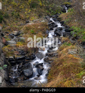 Ruscello di montagna tra le rocce in autunno Foto Stock