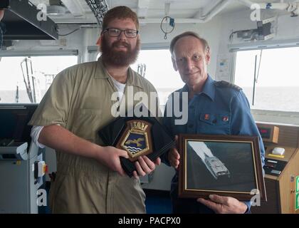 160320-N-WV703-050 del golfo di Guinea (20 marzo 2016) - Capt. Phil Hanton, comandante della flotta reale oro ausiliarie Rover, diritto, scambi di regali a bordo della sua nave con terzo mate Alessandro Spitz, un servizio civile mariner assegnato a USNS Spearhead (T-EPF 1), 20 marzo come parte di esercizio Obangame/Saharan Express 2016. Obangame/Saharan Express uno dei tre African Regional Express series esercizi facilitata dalla U.S. Forze Navali/Europa-africa U.S. Sesta flotta, mira a rafforzare la cooperazione regionale, dominio marittimo la sensibilizzazione, la condivisione di informazioni pratiche e migliorare l'interoperabilità tra partecipanti f Foto Stock