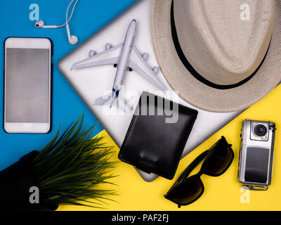 Laptop, aereo giocattolo, hat, smartphone, cuffie, occhiali da sole, azione fotocamera e portafogli Foto Stock