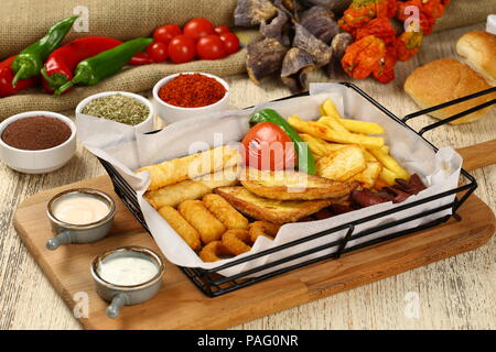 Antipasto Misto di patatine fritte sasusage, le zucchine fritte e pasticceria, sigara borek con salse Foto Stock