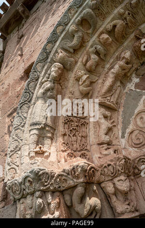 Uomo di catene con il legame del suo collo e piedi. Particolare del portale della chiesa romanica di San Andrés (XII secolo) in Soto de Bureba, provincia di Burgos, Castiglia Foto Stock