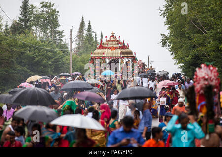 Val-Morin, Canada, 22 luglio 2018. Centinaia di devoti indù riuniti in Val-Morin, Québec per la Kaavadi festival, una celebrazione annuale del Signore Subramanya (o Muruga), il dio indù della guerra. Molti devoti sono sospese mediante ganci e aghi piercing la loro pelle come un modo o penitenza e trascendenza. Altri devoti portano kaavadis (arcate ornate con penne di pavone) sulle loro spalle, come si è creduto che sono ottimi conduttori di energia spirituale. Credito: Cristian Mijea/Alamy Live News. Foto Stock