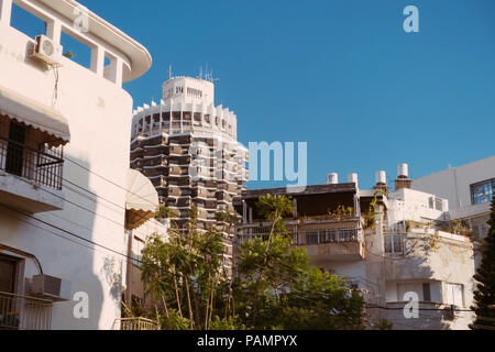 Il marrone e bianco torre cilindrica di Dizengoff picchi di centro su alcuni white bauhaus-ser edifici in Tel Aviv-Yafo, Israele Foto Stock