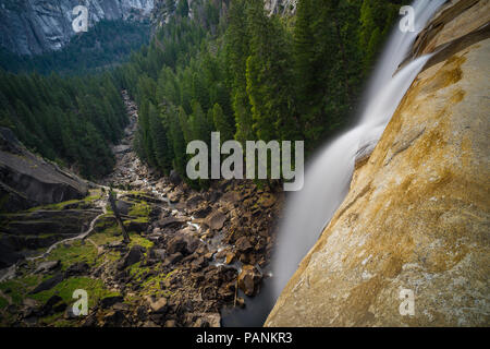 Vista ingrandita di acqua liscia cascading sopra la parte superiore del primaverile cade, giù per la valle al di sotto - Fiume Merced - Parco Nazionale di Yosemite Foto Stock