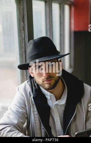 Uomo Barbuto che indossa black hat Foto Stock