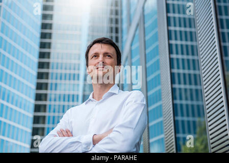 Ritratto di imprenditore fiducioso nella parte anteriore del grattacielo Foto Stock