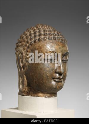La testa di un Buddha. Cultura: Cina (Xiangtangshan meridionale). Dimensioni: H. 15 1/2 in. (39,4 cm); W. 10 a. (25,4 cm); D. 12 a. (30,5 cm). Data: ca. 565-75. Museo: Metropolitan Museum of Art di New York, Stati Uniti d'America. Foto Stock