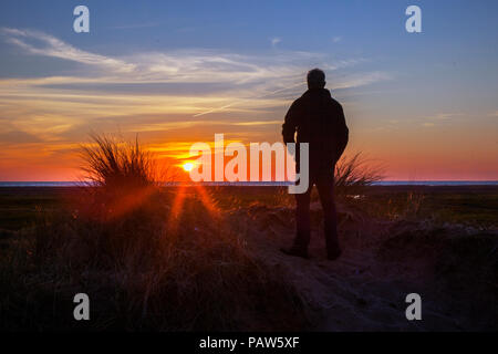 Southport, Merseyside Regno Unito 14 luglio, 2018. Silhouette uomo. Regno Unito Meteo. Colorato tramonto sul Mare d'Irlanda e Ainsdale dune di sabbia riserva naturale nazionale (NNR), che è un 508 ettari comprendente rare dune, spiaggia e gli habitat forestali. Ci sono 10 km di sentieri segnati da seguire, un tranquillo e selvaggio circondato da uno dei la maggior parte delle aree urbane in Inghilterra. Credito: MediaWorldImages/Alamy Live News Foto Stock