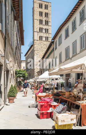 Le bancarelle del mercato in una strada che conduce alla chiesa di Santa Maria della Pieve in Arezzo, Italia Foto Stock