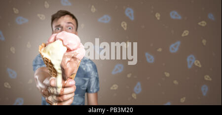 Uomo con un punto di fusione di cono gelato in mano Foto Stock