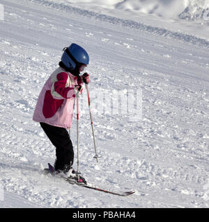 Poco sciatore sulla neve sulle piste da sci in inverno freddo mattino Foto Stock