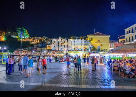 La fantastica città costiera di Parga di notte. Turisti e visitatori di camminare lungo la costa vicino alla bellissima decorata dai negozi e dai ristoranti. Parga, Foto Stock