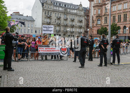 Wiesbaden, Germania. Il 29 luglio 2018. Il contatore i manifestanti sono separate da funzionari di polizia dall'ala destra protestare. A destra i manifestanti di mano in mano - Gegen die Gewalt auf unseren Strasen (mano nella mano - contro la violenza sulle nostre strade) movimento tenuto un governo anti-rally di Wiesbaden. La protesta si è svolta sotto il pretesto di una veglia per l'adolescente Susanna F, che sarebbe stato ucciso da un rifugiato a Wiesbaden. Il rally è stato affrontato da diversi anti-casse del governo, che ha chiesto al governo di dimettersi. Foto Stock