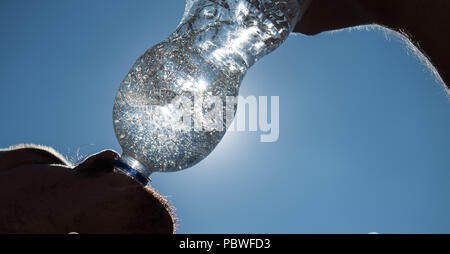 Stuttgart, Germania. Il 30 luglio, 2018. Un uomo beve acqua da una bottiglia. Credito: Sebastian Gollnow/dpa/Alamy Live News Foto Stock