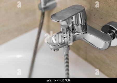 Doccia e vasca da bagno miscelatori in un bagno. Foto Stock