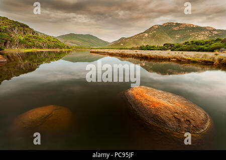 Colorato di lichene, rocce coperte al fiume di marea in Wilsons Promontory National Park. Foto Stock