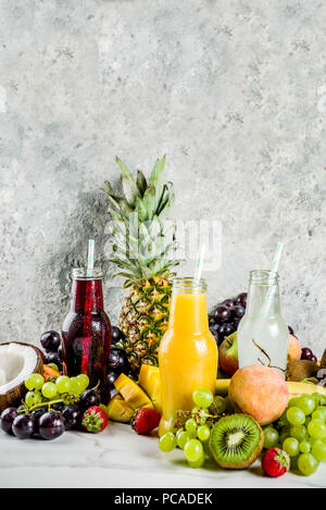 Diversi succhi di frutta frullati concetto, estate vitamine dieta, con frutti tropicali e bacche su uno sfondo luminoso, Foto Stock