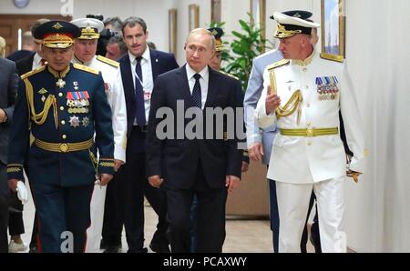 Il presidente russo Vladimir Putin, centro visite della Nakhimov Scuola Navale della Marina Militare durante le celebrazioni della festa il 29 luglio 2018 a San Pietroburgo, Russia. A piedi con Putin sono testa della Nakhimov Scuola Navale Anatoly Minakov, destro e il ministro della Difesa Sergei Shoigu. Foto Stock