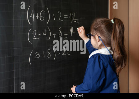 Italiano Scuola elementare ragazza prima-grader risolvere la matematica Foto Stock