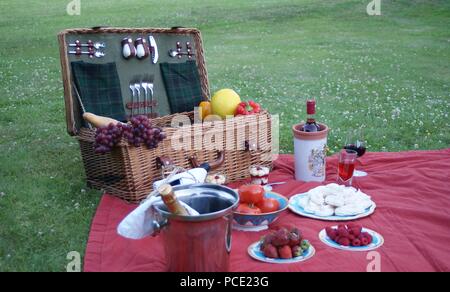 Inglese Cesto picnic sulla coperta picnic con tante prelibatezze e bevande Foto Stock