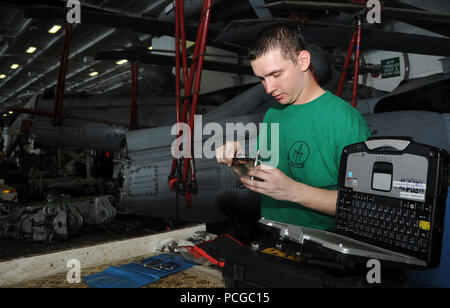 Stati Uniti Aviazione Navale meccanico strutturale di terza classe Darryl Shawn, assegnato al mare in elicottero Combat Squadron (HSC) 9, misure un bullone a bordo della portaerei USS George H.W. Bussola (CVN 77)nel Golfo Persico Luglio 7, 2014. Il George H.W. Bush è stato sostenere le operazioni di sicurezza marittima e di teatro la cooperazione in materia di sicurezza gli sforzi negli Stati Uniti Quinta Flotta area di responsabilità. Foto Stock