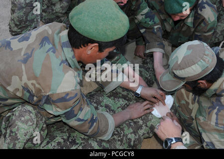 Esercito Nazionale Afghano soldati pratica pressione diretta medicazioni durante il training, 9 giugno. Questa istruzione incluso anche l'applicazione pratica del combattimento tourniquets. Foto Stock