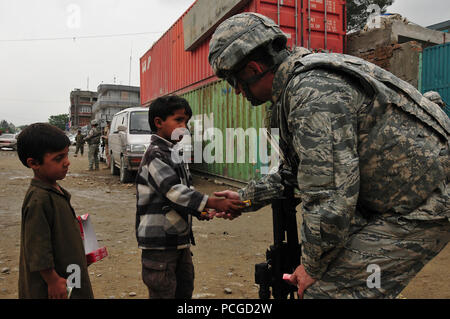 Lt. Col. Kevin Yandura, una NATO aria comando di formazione - Afghanistan advisor, colloqui con due giovani bambini afgani durante un aiuto umanitario di missione. ( Foto Stock