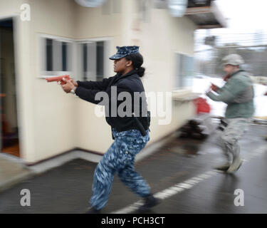 MISAWA COMBATTÉ AIR BASE, Giappone (feb. 13, 2013) Master-at-Arms di terza classe Jasmine Morrison, da Fayetteville, Ga., avanza ad un bersaglio durante un anti-terrorismo protezione forza di esercizio a Misawa combatté la base dell'aria. Durante il corso di formazione evoluzione, marinai da Naval Air Facility Misawa combatté e aviatori di Misawa combatté Air Base hanno lavorato insieme per completare correttamente l'esercizio. Foto Stock
