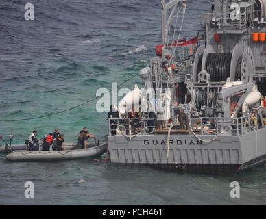 Mare di Sulu, Filippine (GEN. 22, 2013) DEGLI STATI UNITI Navy valutazione di soccorso ai membri del team di bordo la miniera contromisure nave USS Custode (MCM 5). La nave si è arenata su di Tubbataha Reef a Gennaio 17. Le operazioni per ripristinare in modo sicuro la nave minimizzando al contempo gli effetti ambientali sono condotte in stretta collaborazione con allied Filippine Guardia Costiera e marina. Foto Stock