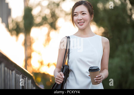 Certi giovani cinesi imprenditrice tenendo una tazza di caffè Foto Stock