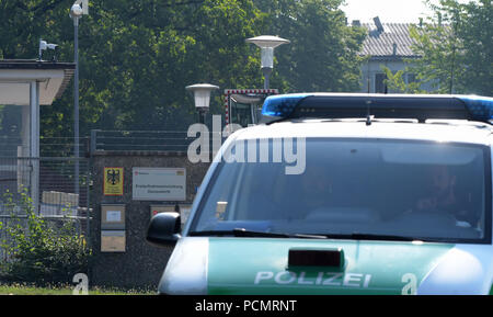 Donauwoerth, Germania. 03 Ago, 2018. Una macchina della polizia passa l'entrata dell'Ankerzentrum. Le forze di polizia cercati due case in comunità di ricovero per i profughi. La polizia ha riferito che i residenti avevano depositato oggetti pericolosi nelle loro camere al fine di utilizzarli in possibili conflitti. I controlli sui sospetti è servito a proteggere gli altri residenti e lavoratori dipendenti. Credito: Stefan Puchner/dpa/Alamy Live News Foto Stock