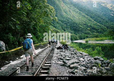 I turisti a piedi lungo i binari ferroviari da Hidroelectrica ad Aguas Calientes, Perù. Le 2 ore e mezzo a piedi (12km) è piena di incredibili panorami. Giu 2018 Foto Stock