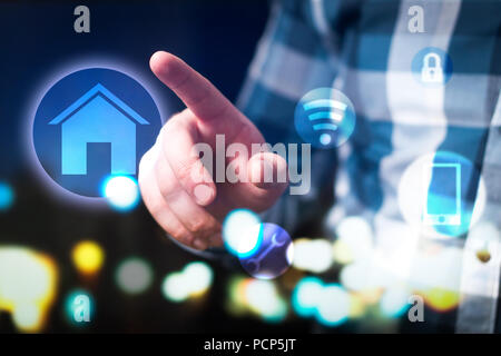 Smart home e internet delle cose (IOT) concetto. Uomo con casa moderna protezione, connessione e sistema di controllo. Interfaccia astratta. Foto Stock