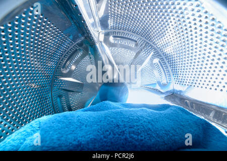 Moderna macchina di lavaggio caricata con asciugamano blu Foto Stock