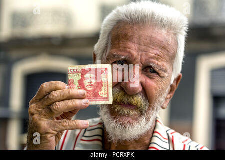 Il vecchio uomo cubano detiene una tre pesos banconota con il ritratto di Ernesto Che Guevara in mano, valuta locale, coppa, peso cubano, la povertà, La Habana, Havana, La Habana, Cuba, Cuba Foto Stock