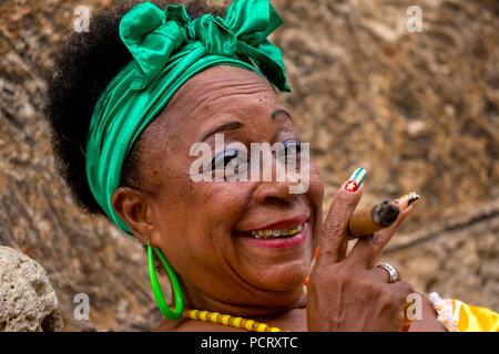Vecchia donna cubana con i capelli verdi ribbon fuma un sigaro Havana, Caraibi, America centrale, La Habana, Cuba Foto Stock