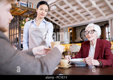 Bere il caffè al caffè Foto Stock