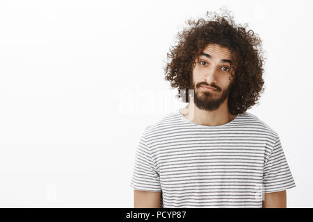 Vita-up ritratto di gentile carino ispanico fidanzato con la barba e acconciatura afro, indossa casual striped t-shirt, testa tiltante e ammirate la fotocamera Foto Stock