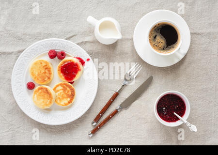 Cottage cheese pancake con confettura di lamponi e caffè. Vista dall'alto. Syrniki o sirniki, cucina russa gli agricoltori frittelle di formaggio o pancake Foto Stock