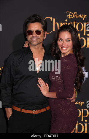 John Stamos, Caitlin McHugh 30/07/2018 La prima mondiale di "Christopher Robin" tenutasi presso il Walt Disney Studios di Burbank, CA Foto di Izumi Hasegawa / HollywoodNewsWire.co Foto Stock