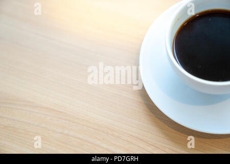 Vista dall'alto la metà di bianco tazza di caffè sul tavolo in legno Foto Stock