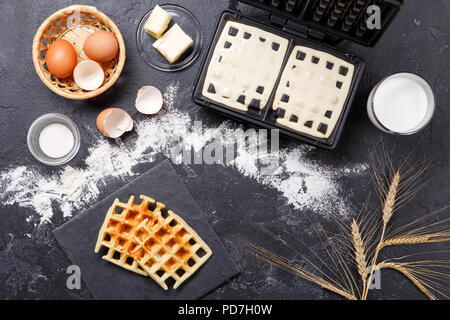 Foto in alto di farina, uova, waffle ferro, picchi, fette fritte Foto Stock