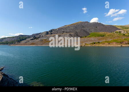 L'enorme Dinorwic cava di ardesia sul lato di Elidir Fawr. Visto attraverso Llyn Peris il lago inferiore della pompa Dinorwig storage power station. Foto Stock