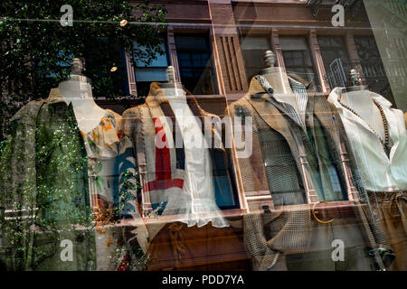 A passerby tests a new interactive holographic screen on a Polo Ralph Lauren  store window that allows people to buy shirts, skirts and pants from the  company's U.S. Open tennis clothing line