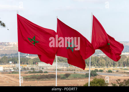 Tre marocchini bandiere nazionali battenti dai pali vicino alla Tour Hassan a Rabat Foto Stock